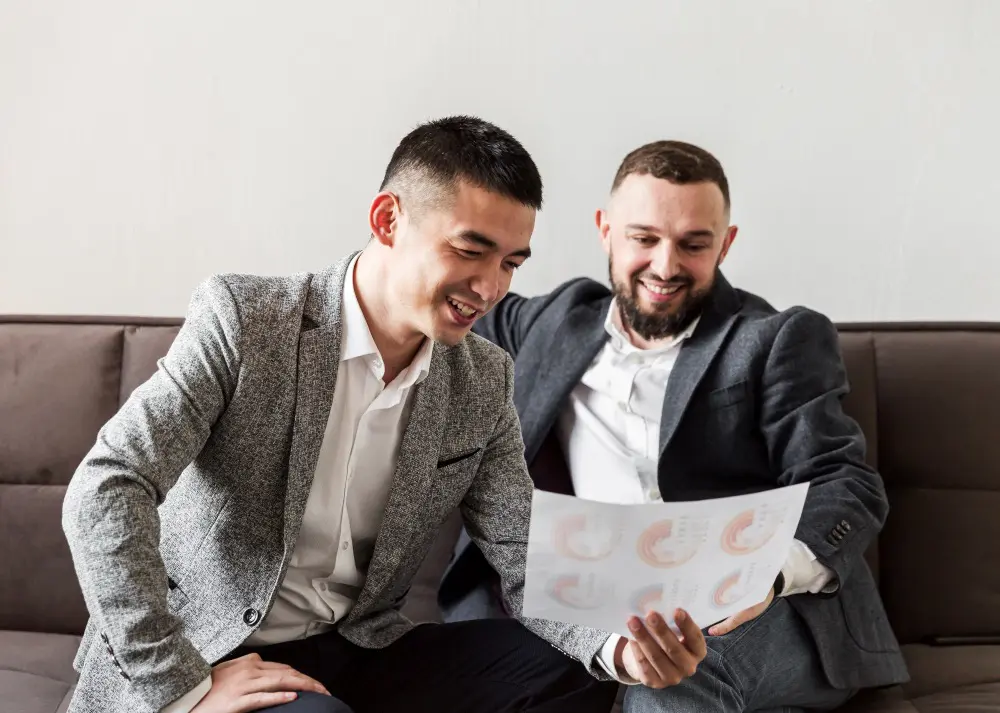 Successful Real Estate Investors Reviewing Property Investment Opportunities