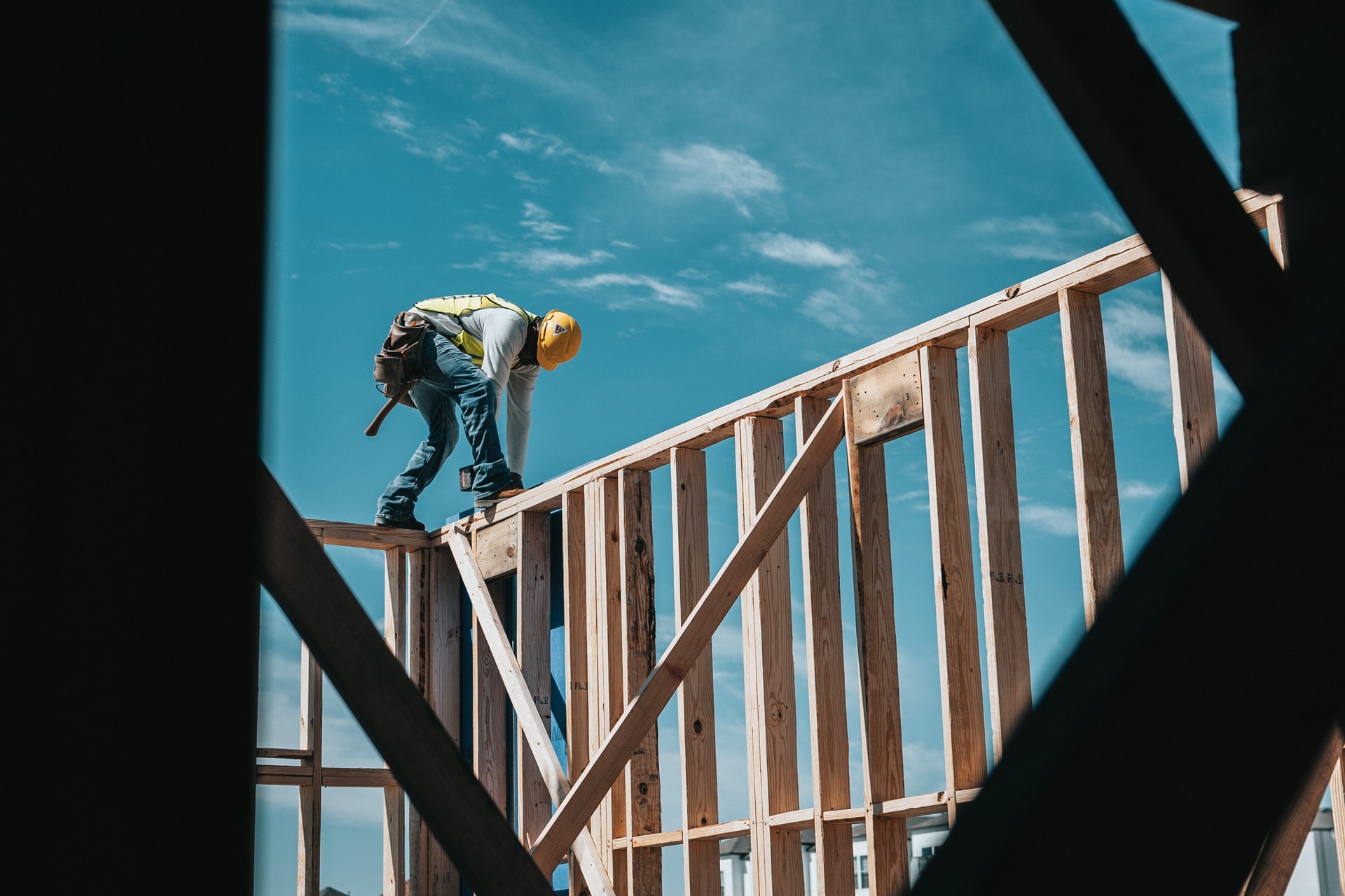 man on top of wooden frame on construction site
