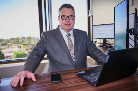 Alan Enochs, San Diego Real Estate Attorney at Desk in Office